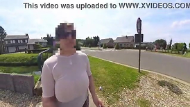 A ginormous- natural cougar walking in the street undressed to the midbody with transparent top.