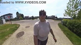 A ginormous- natural cougar walking in the street undressed to the midbody with transparent top.